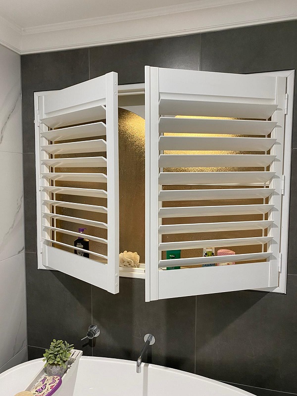 White PVC Plantation Shutters with 2 panels opened in a bathroom setting in Dewhurst 3808 VIC